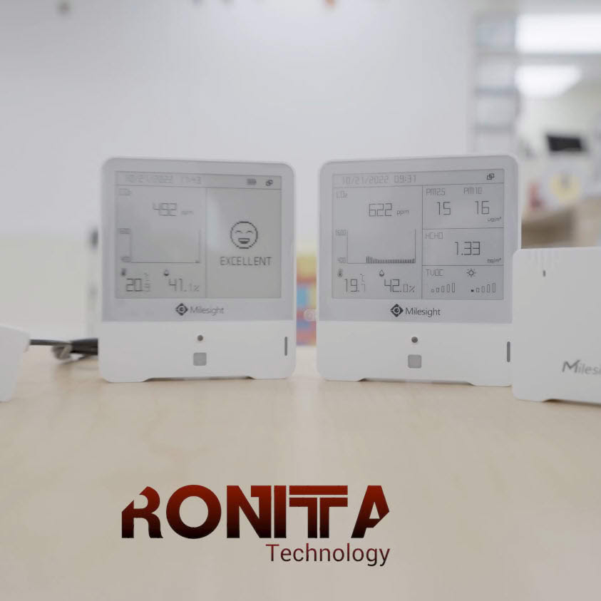 White electronic devices displayed against a technical background during a product demonstration.
