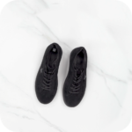 Pair of black footwear items positioned beside each other on a clean white background.