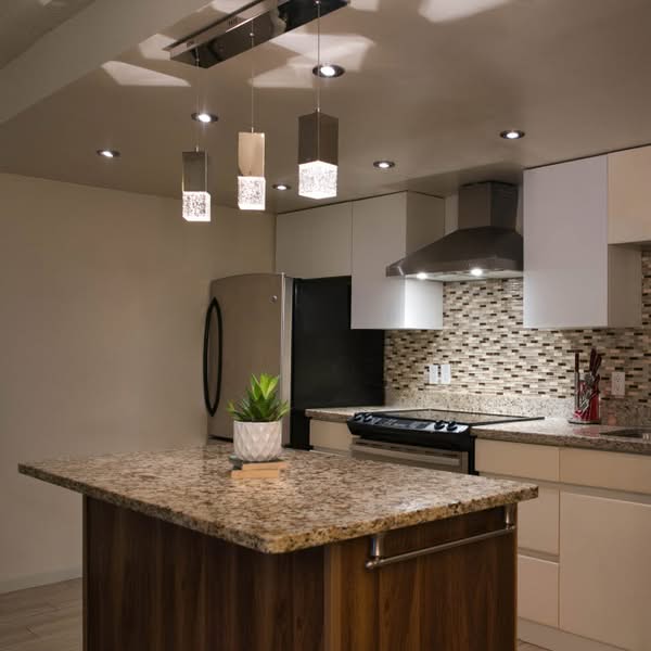 Contemporary residential interior with modern furniture, warm lighting and neutral finishes.
