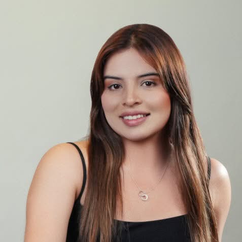 Smiling brunette woman wearing a black sleeveless top during a professional studio headshot session in Vancouver