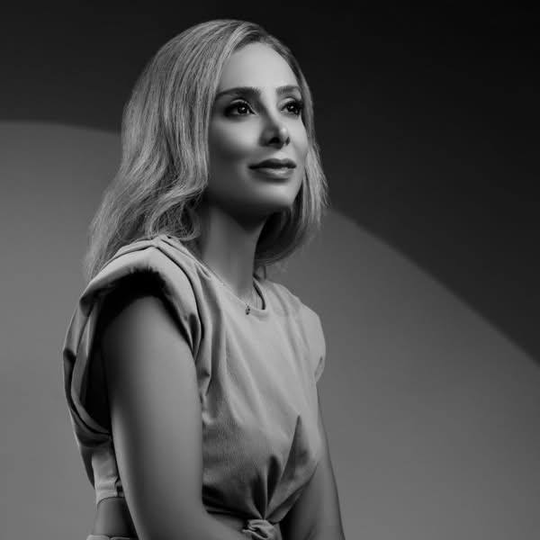 Black and white profile portrait of a blonde woman looking upward under dramatic studio lighting